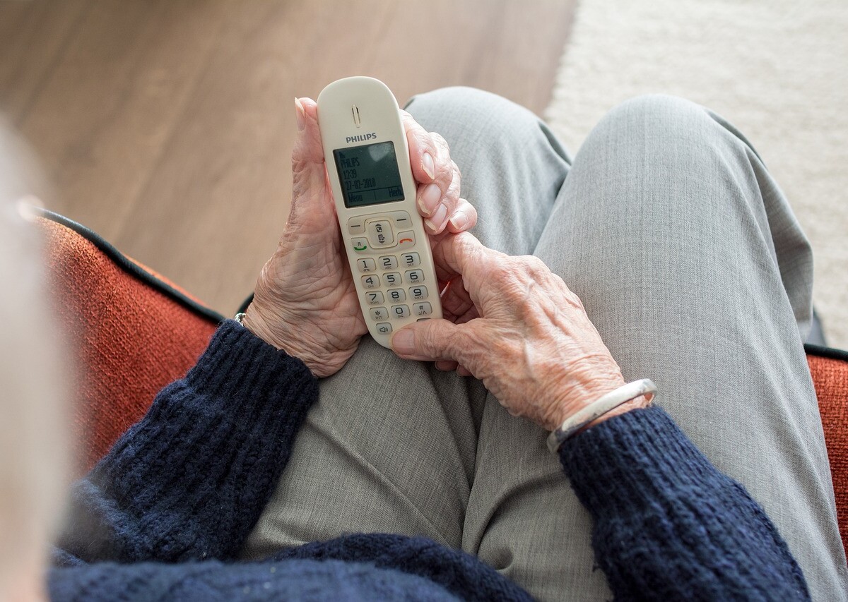 Elderly woman holding a phone