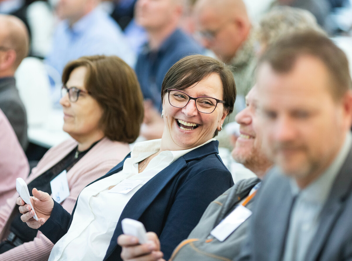 Woman laughing at a banking conference