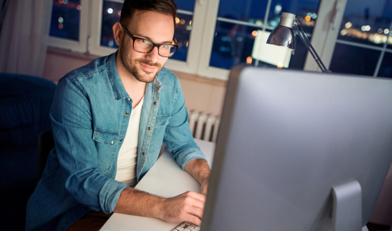 Man working at his computer at night
