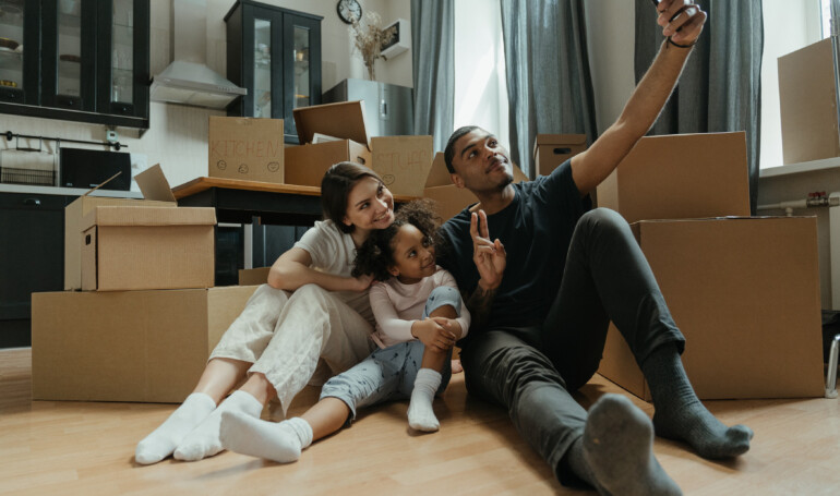 family in house with moving boxes
