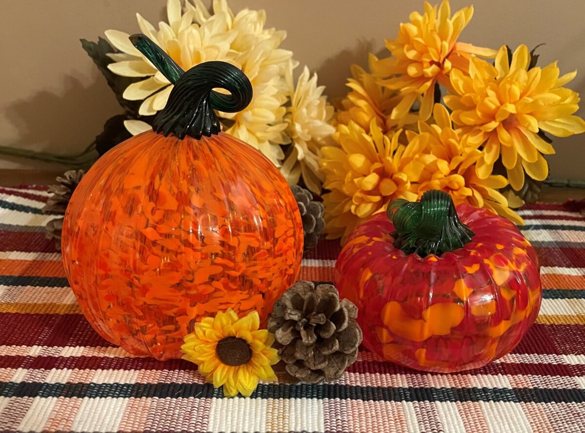 two different glass blown pumpkin images in fall setting