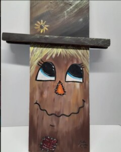 Whimsical scarecrow on pine board