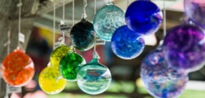 different color glass blown balls hanging from ceiling 