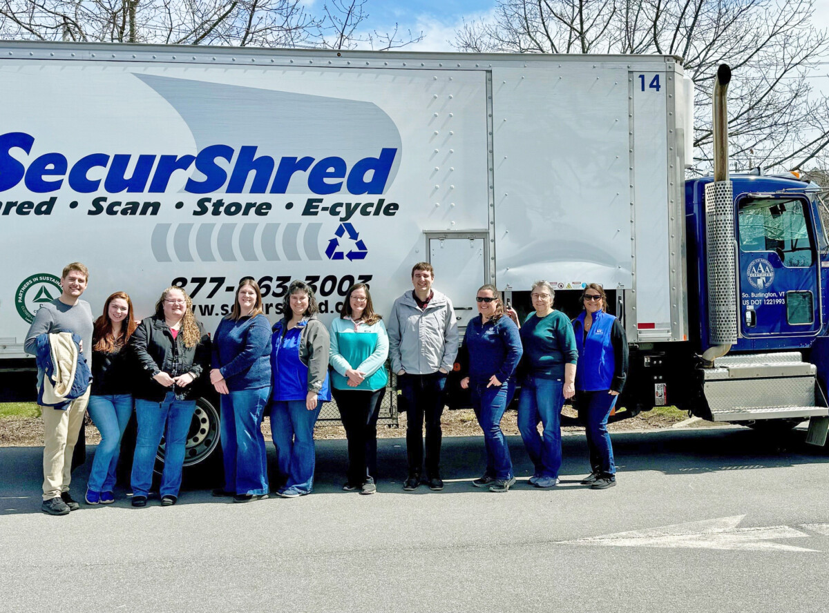 group of people in front of SecurShred truck